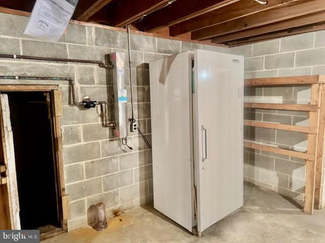 basement featuring white fridge