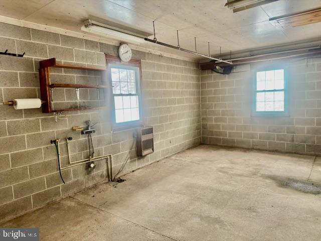 basement with heating unit and a healthy amount of sunlight