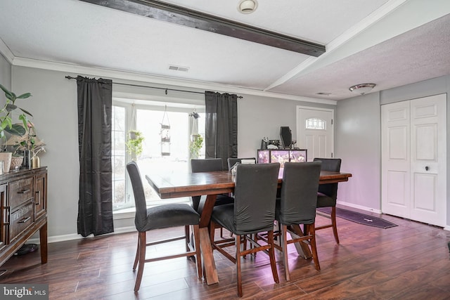 dining space with a textured ceiling, dark hardwood / wood-style floors, ornamental molding, and lofted ceiling with beams