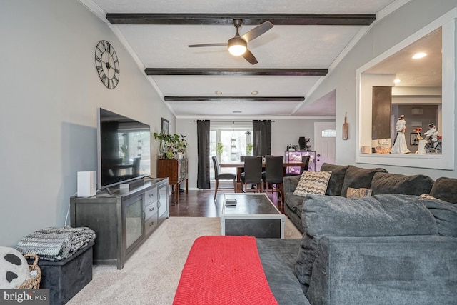 living room with ceiling fan, carpet flooring, and lofted ceiling with beams