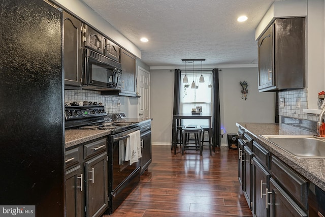 kitchen featuring dark hardwood / wood-style flooring, sink, backsplash, and black appliances