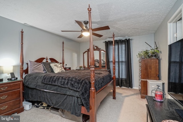 carpeted bedroom with ceiling fan and a textured ceiling