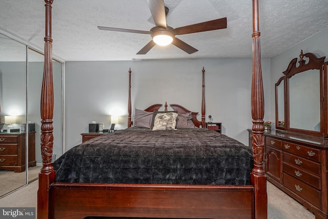 bedroom featuring ceiling fan, light colored carpet, and a closet