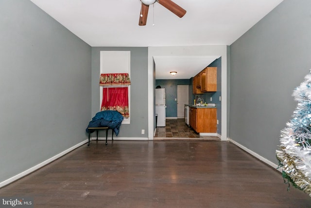 interior space with ceiling fan, dark hardwood / wood-style flooring, and sink