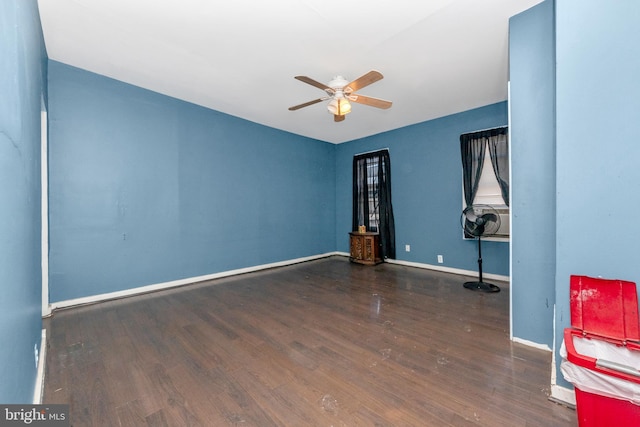 spare room featuring ceiling fan and dark hardwood / wood-style flooring