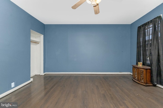 unfurnished living room featuring dark hardwood / wood-style floors and ceiling fan