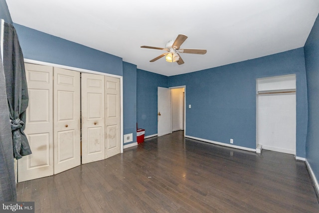 unfurnished bedroom featuring ceiling fan and dark hardwood / wood-style floors