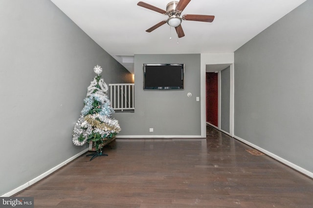 interior space featuring ceiling fan and dark hardwood / wood-style floors