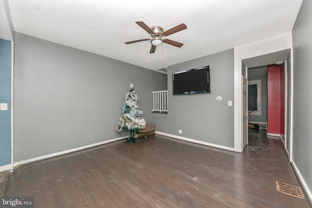 spare room featuring dark hardwood / wood-style floors and ceiling fan