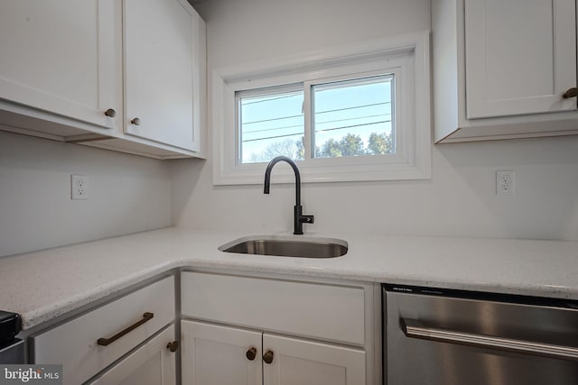 kitchen with sink, white cabinetry, dishwasher, and light stone countertops