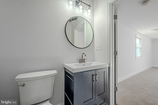 bathroom with toilet and vanity