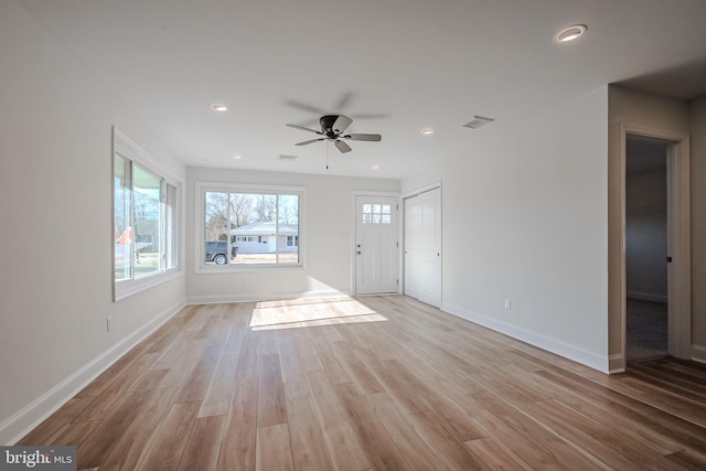 unfurnished living room featuring ceiling fan and light hardwood / wood-style flooring