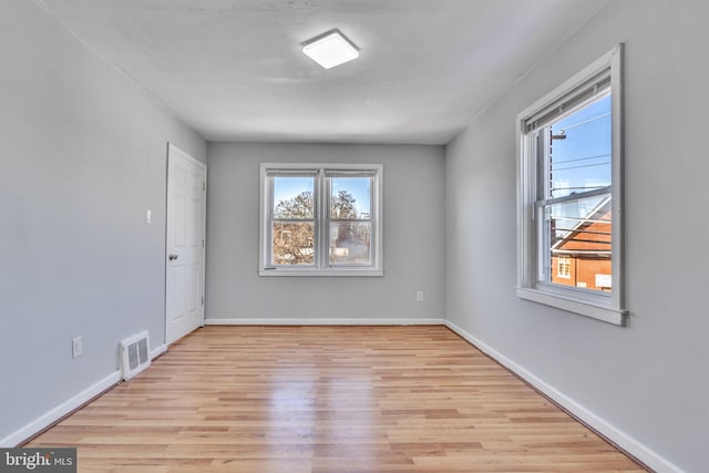 unfurnished room with light hardwood / wood-style flooring