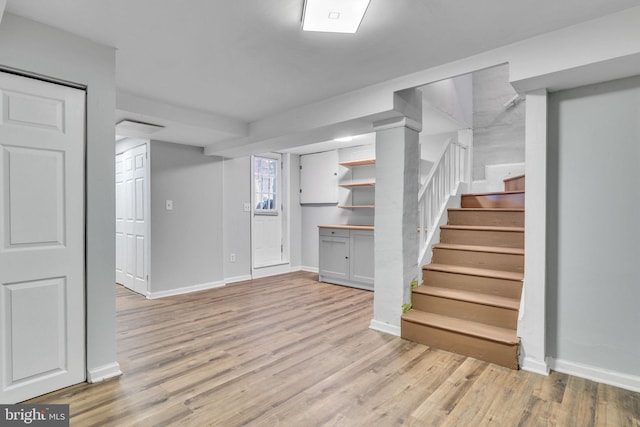 basement with light hardwood / wood-style flooring