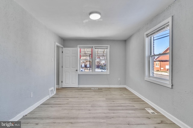 unfurnished room with light wood-type flooring