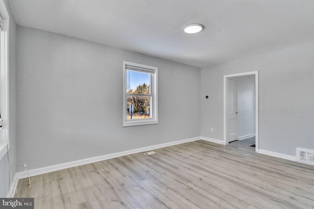 spare room with light hardwood / wood-style flooring