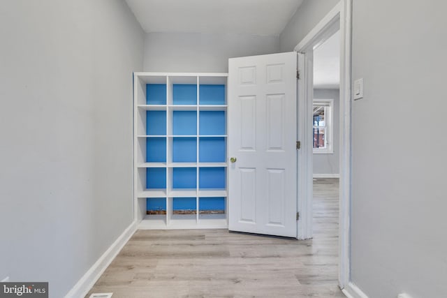 corridor featuring light hardwood / wood-style floors