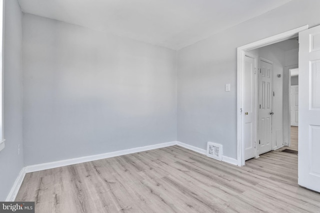 spare room with light hardwood / wood-style flooring