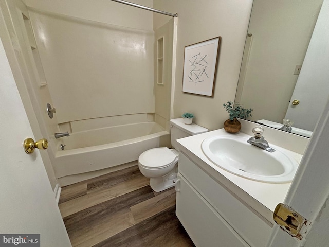 full bathroom featuring toilet, vanity, wood-type flooring, and  shower combination