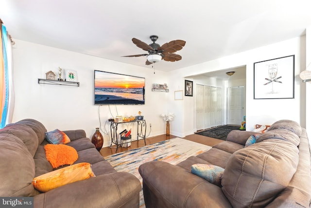 living room with ceiling fan and hardwood / wood-style floors