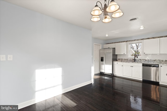 kitchen featuring decorative backsplash, sink, stainless steel appliances, white cabinets, and light stone counters