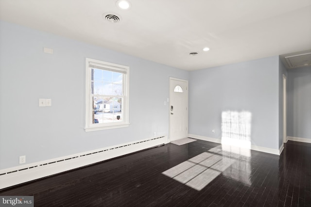 foyer entrance featuring a baseboard heating unit and dark wood-type flooring