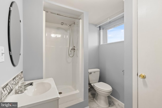 bathroom with toilet, a shower, and vanity