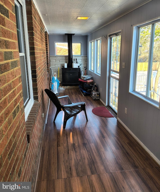 sunroom featuring a wood stove