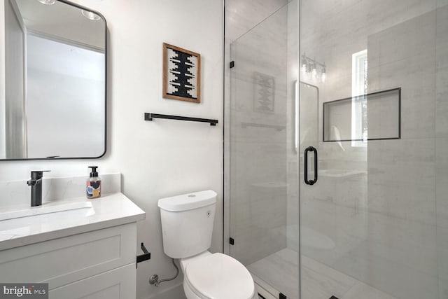 bathroom with vanity, walk in shower, and toilet