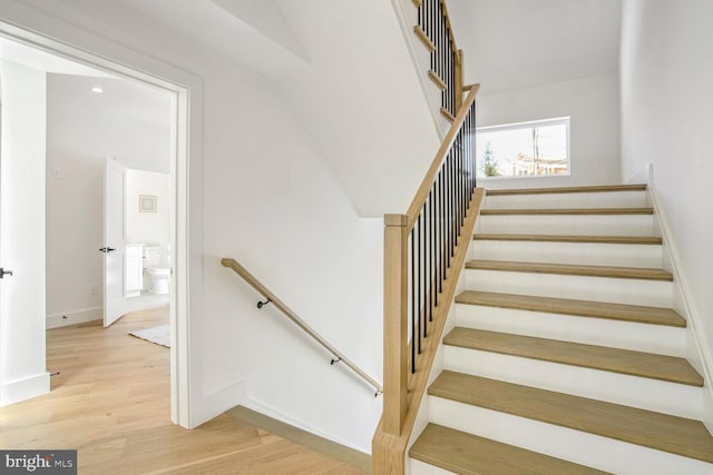 stairs featuring hardwood / wood-style floors