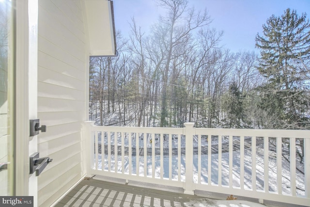 view of snow covered back of property