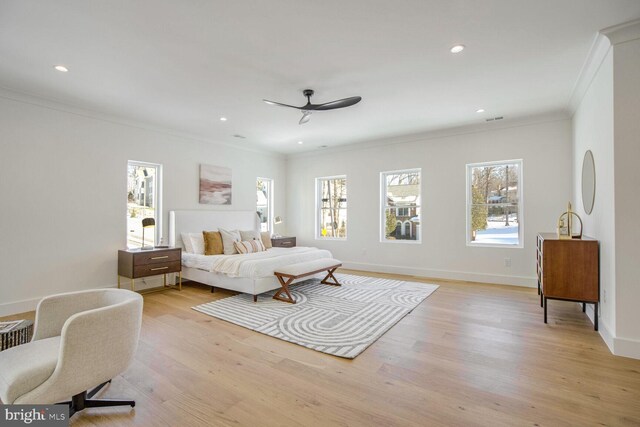 bedroom with crown molding, ceiling fan, and light hardwood / wood-style floors