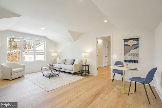 living room with vaulted ceiling and light hardwood / wood-style floors