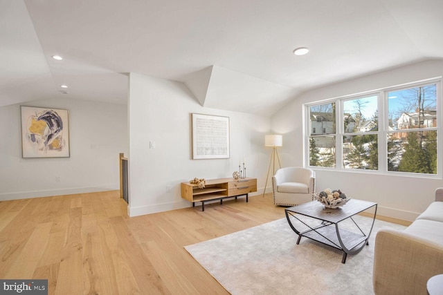 sitting room featuring lofted ceiling and light hardwood / wood-style flooring