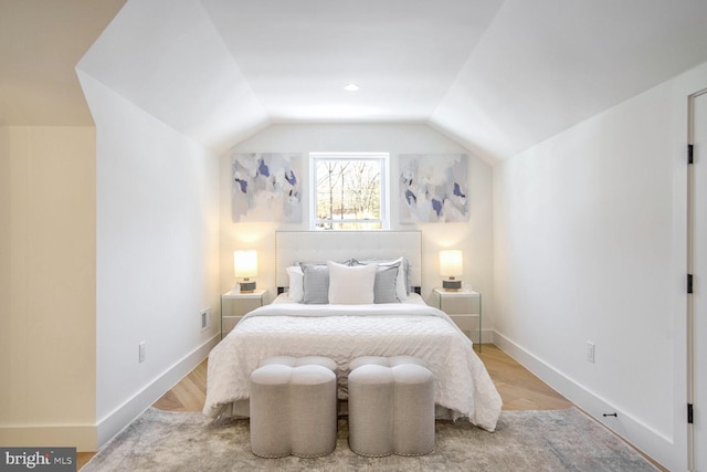 bedroom featuring light hardwood / wood-style flooring and vaulted ceiling