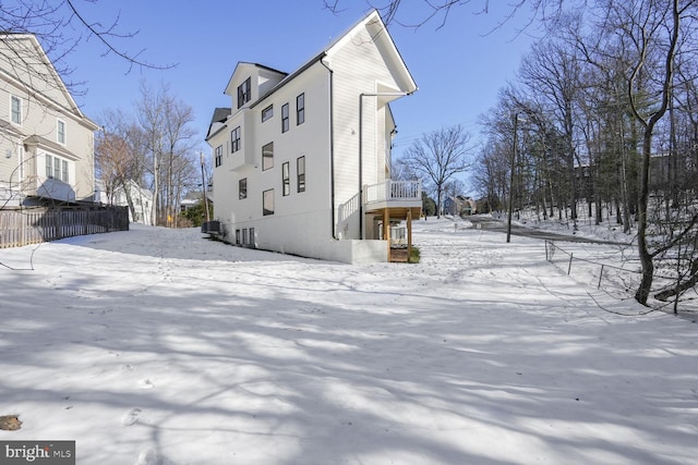 view of snow covered exterior featuring central AC