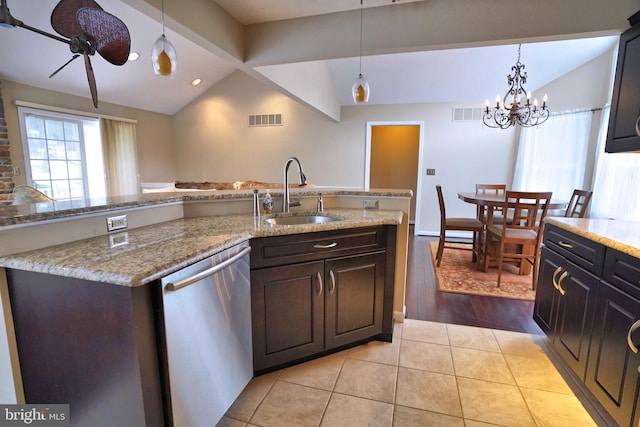 kitchen with stainless steel dishwasher, lofted ceiling with beams, sink, and dark brown cabinetry