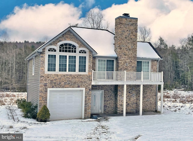 view of front facade featuring a garage and a balcony