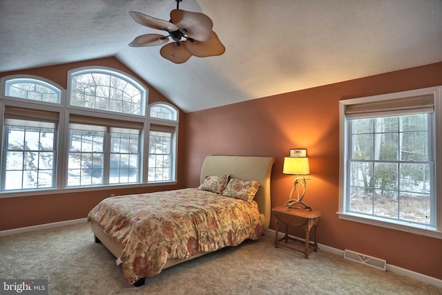 bedroom featuring ceiling fan, carpet floors, and multiple windows