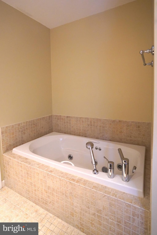 bathroom featuring tiled bath and tile patterned floors