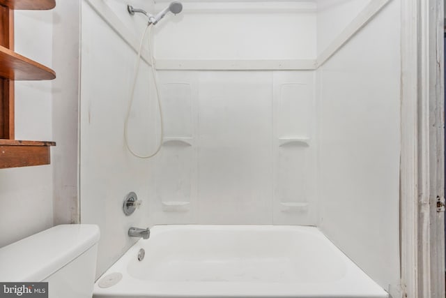 bathroom featuring shower / tub combination and toilet