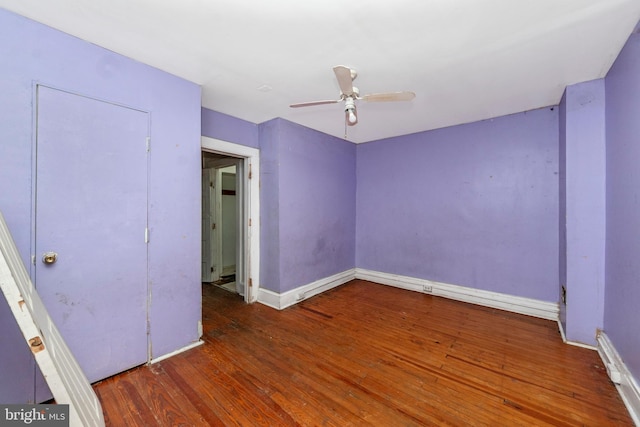 unfurnished bedroom featuring dark hardwood / wood-style flooring and ceiling fan