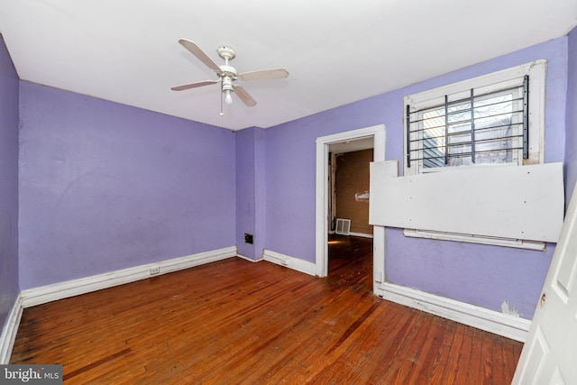 spare room with ceiling fan and dark hardwood / wood-style floors