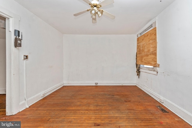 spare room with hardwood / wood-style floors and ceiling fan