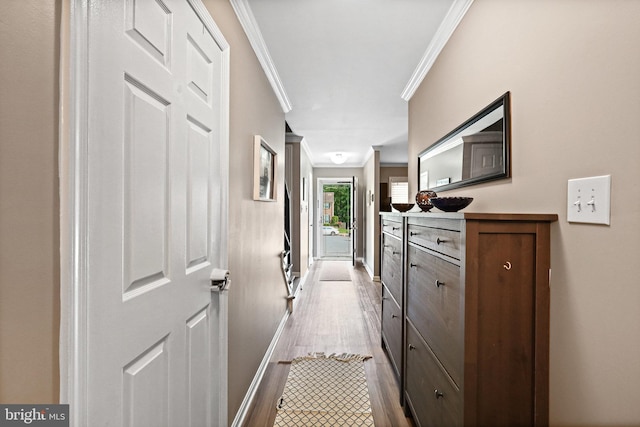 corridor featuring crown molding and light hardwood / wood-style flooring