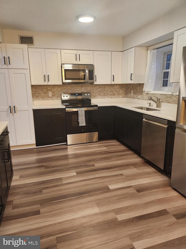 kitchen with white cabinetry, sink, and appliances with stainless steel finishes