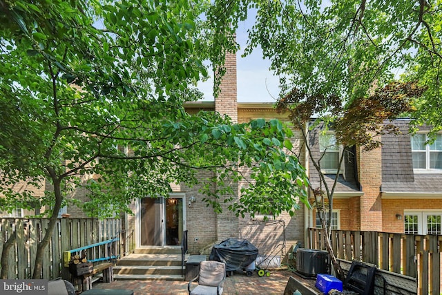 back of property featuring central AC unit