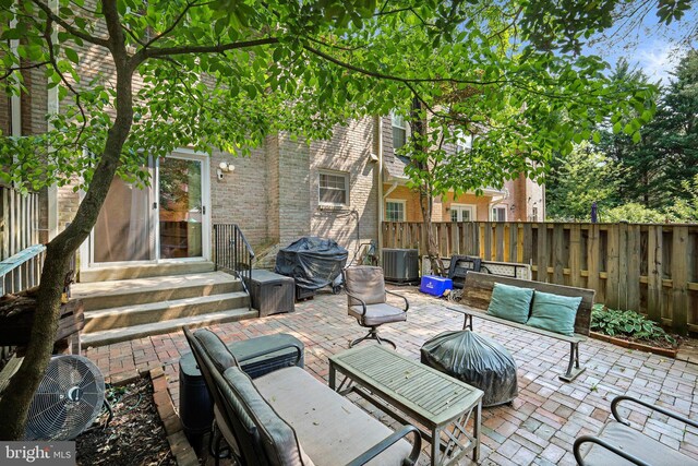 view of patio featuring cooling unit, an outdoor living space, and grilling area