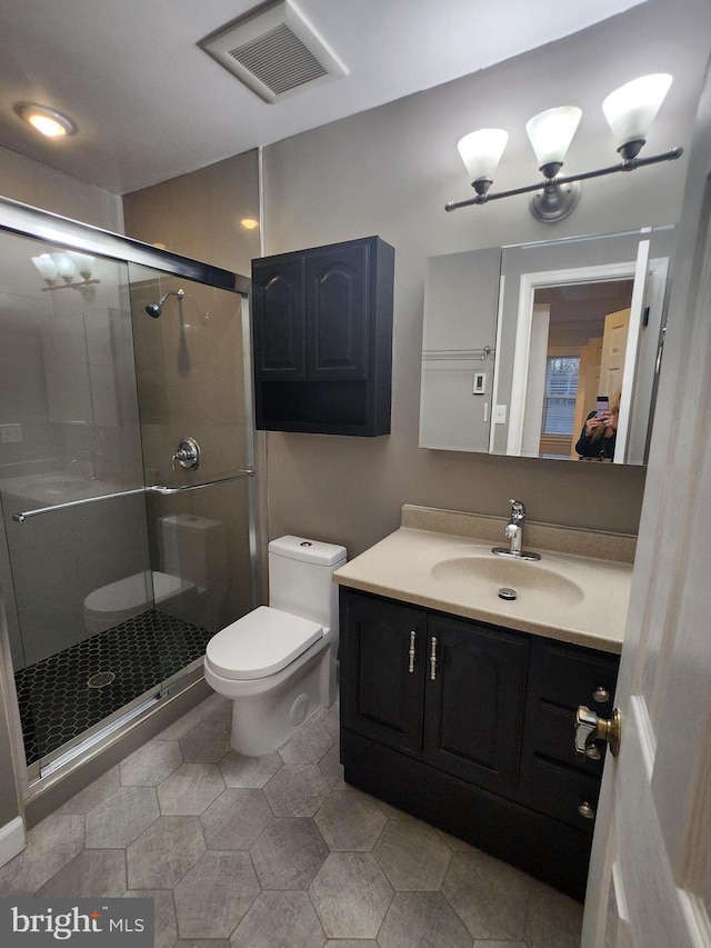 bathroom with walk in shower, vanity, and toilet