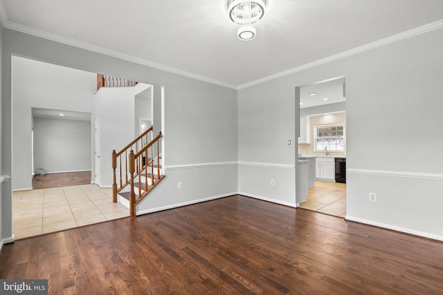 empty room with crown molding and light hardwood / wood-style floors